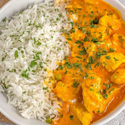 A bowl of rice and chicken.
