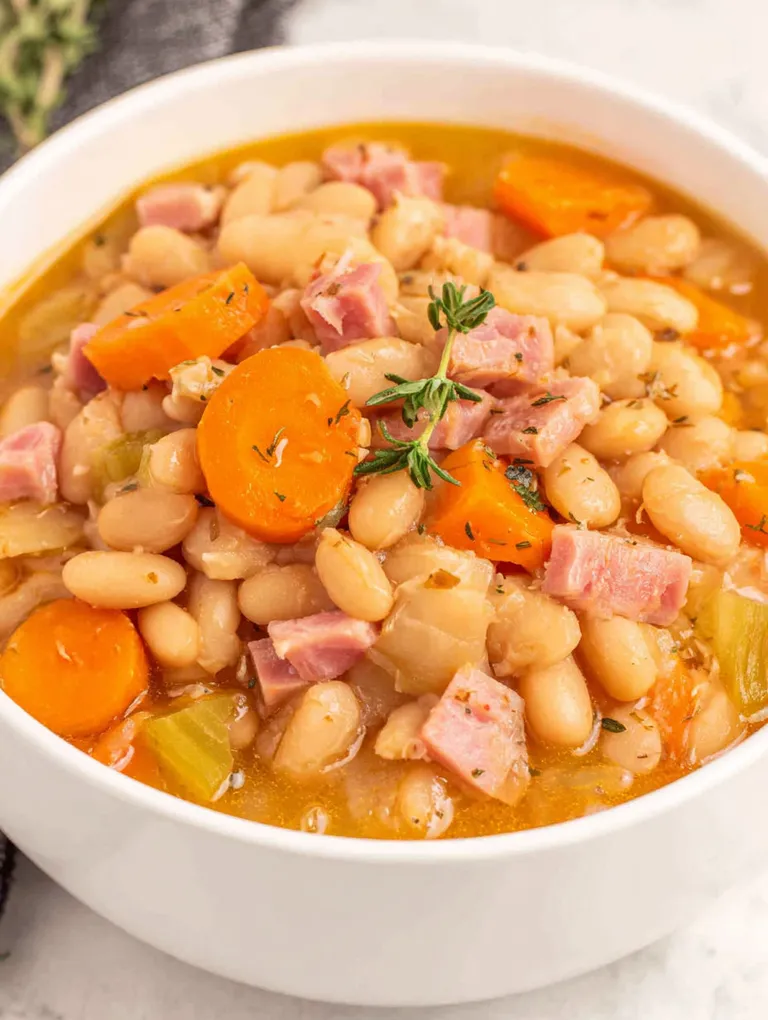 A bowl of soup with meat and vegetables.