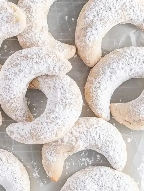 Almond crescent cookies on a table.