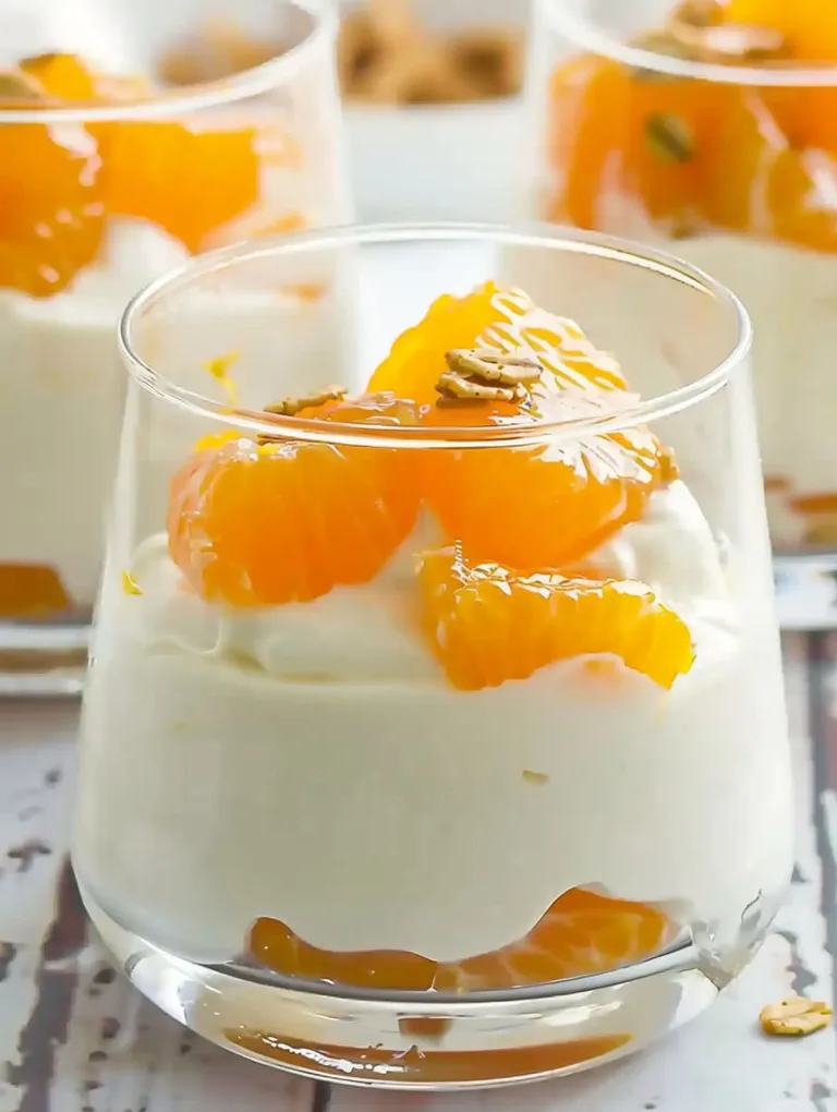 A glass of orange cream dessert.