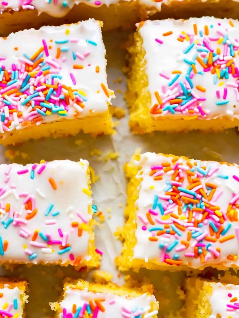 A close up of a piece of cake with sprinkles.