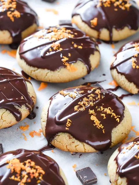 Chocolate chip cookie with orange sprinkles.