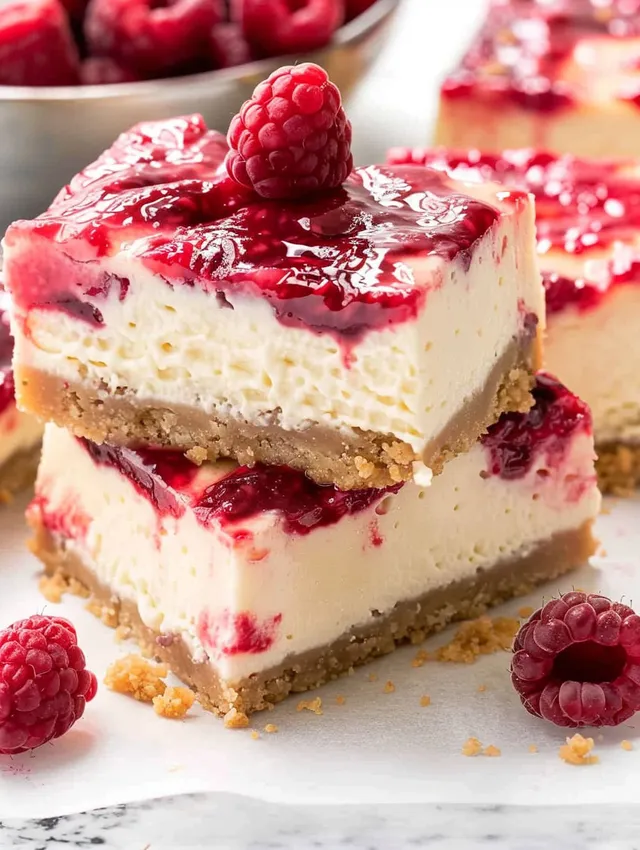 A slice of raspberry swirl cheesecake bars.