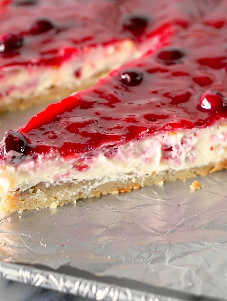 A slice of lemon raspberry fruit pizza.