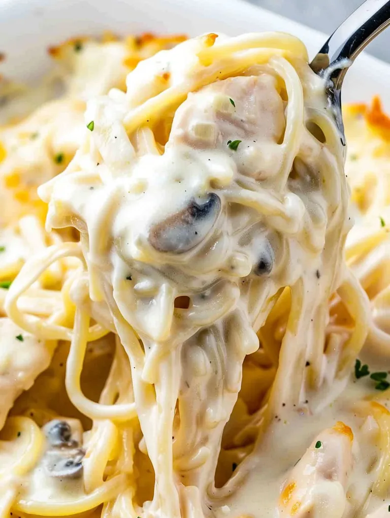 A fork is in a bowl of chicken tetrazzini.