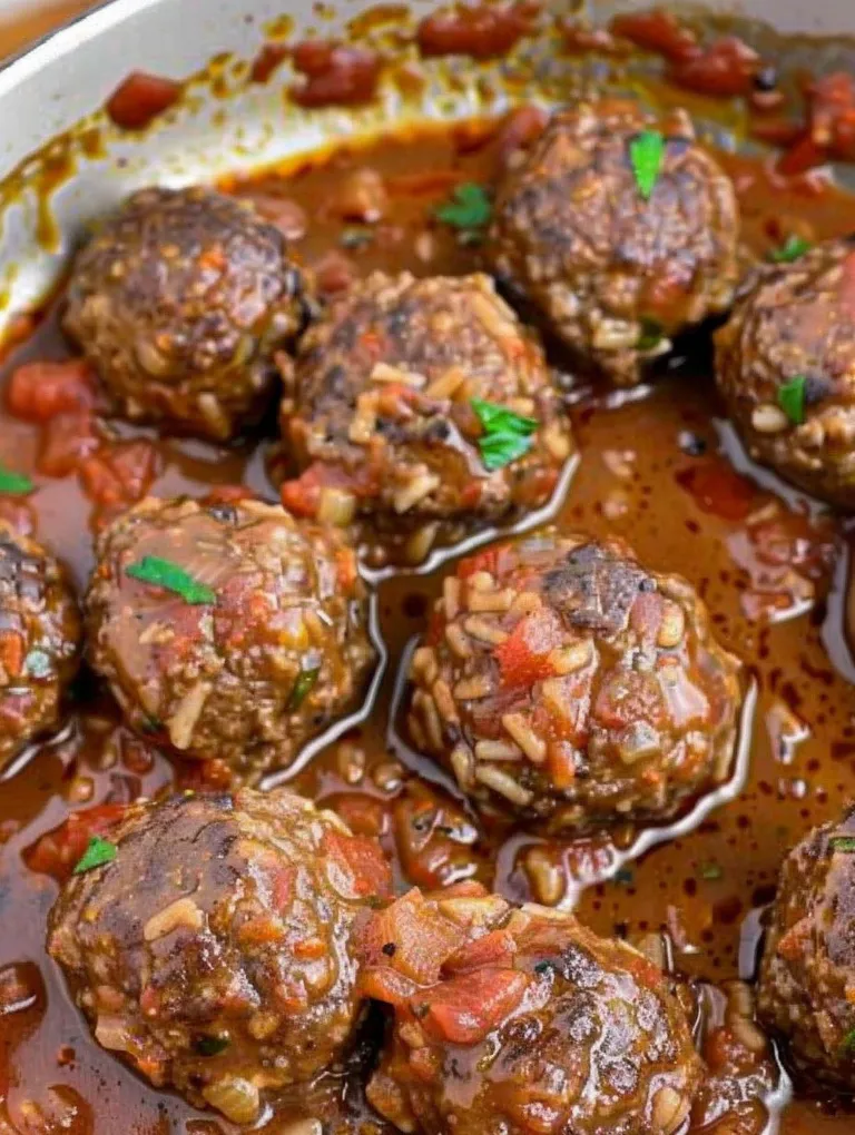A dish of meatballs in a brown sauce.
